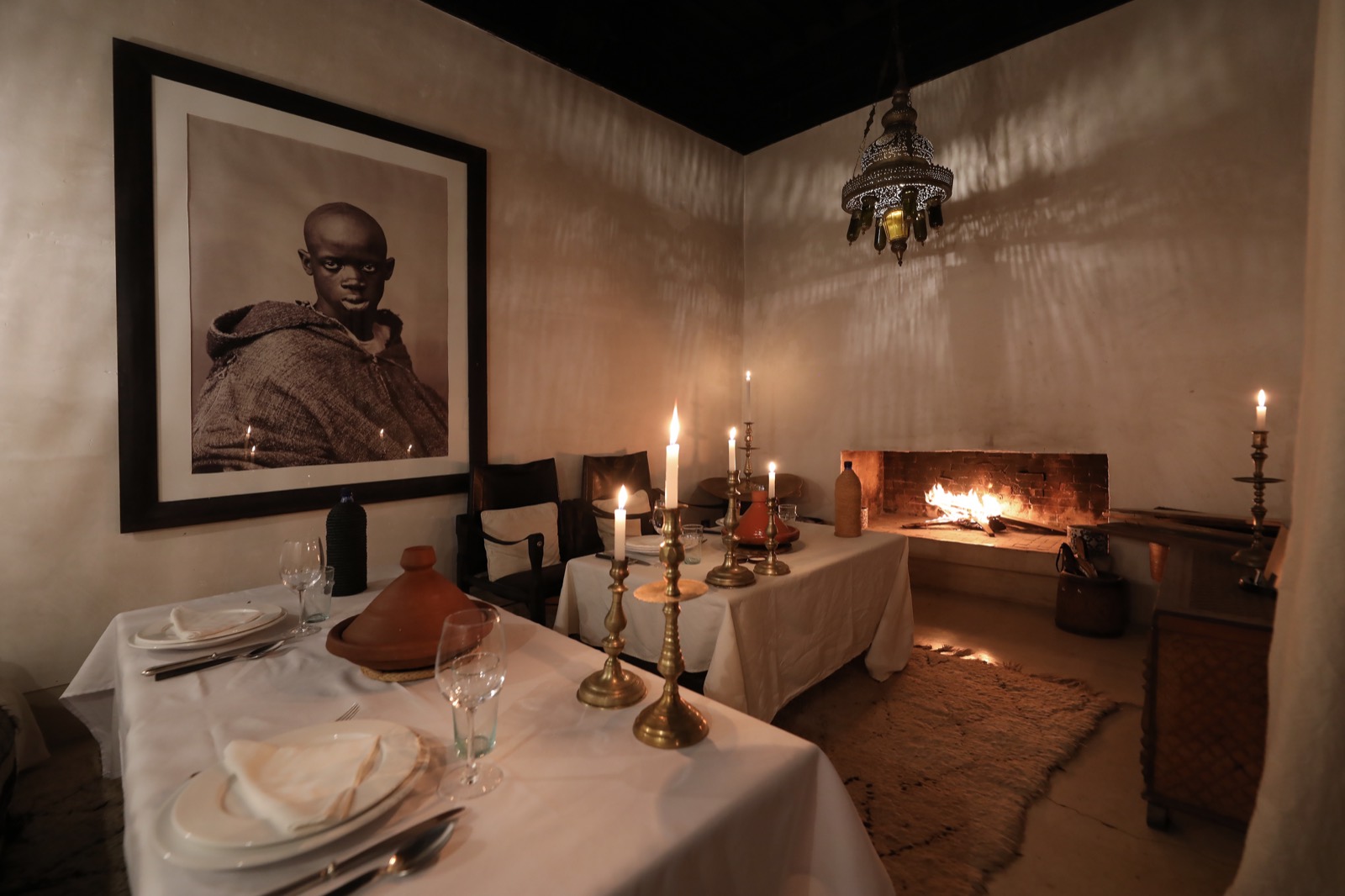 La table dressée aux chandelles dans le salon, devant les bougeoirs et le portrait